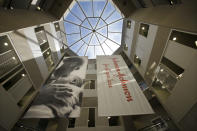 FILE - In this July 30, 2013, file photo, large banners hang in an atrium at the headquarters of Johnson & Johnson in New Brunswick, N.J. Johnson & Johnson is beginning a huge final-stage study Wednesday, Sept. 23, 2020, to try to prove if a single-dose COVID-19 vaccine can protect against the virus. (AP Photo/Mel Evans, File)