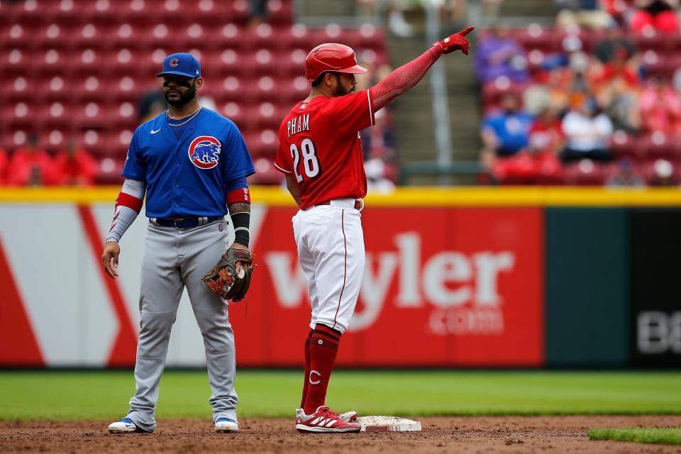Cincinnati Reds left fielder Tommy Pham (28) points back to the Reds dugout after tying the game with an RBI double in the third inning of the MLB National League game between the Cincinnati Reds and the Chicago Cubs at Great American Ball Park in downtown Cincinnati on Thursday, May 26, 2022. The Reds led 10-3 after three innings. 