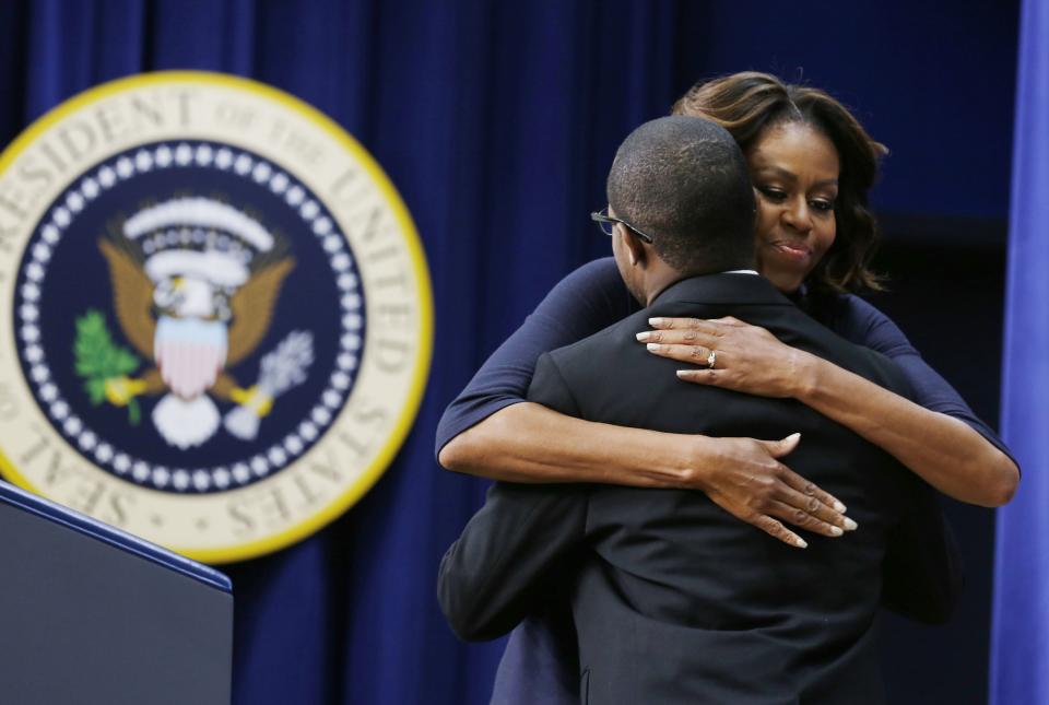 U.S. first lady Obama hugs New Orleans student Simon before she gives remarks at an event on Expanding College Opportunity in Washington
