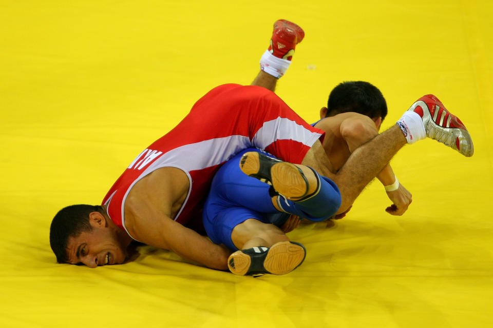 Roman Amoyan (red) of Armenia competes against Asset Imanbayev of Kazakhstan in their Men's Greco-Roman 55 kg qualifying wrestling event during Day 4 of the Beijing 2008 Olympic Games at the China Agriculture University Gymnasiumon August 12, 2008 in Beijing, China. (Stu Forster/Getty Images)