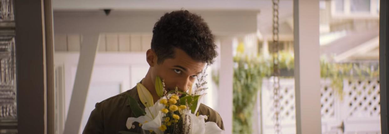 Aidan holding a bouquet of flowers on a porch