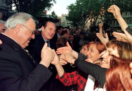FILE PHOTO: German Chancellor Helmut Kohl and French President Jacques Chirac shake hands with well-wishers at the start of the Franco-German summit in Avignon