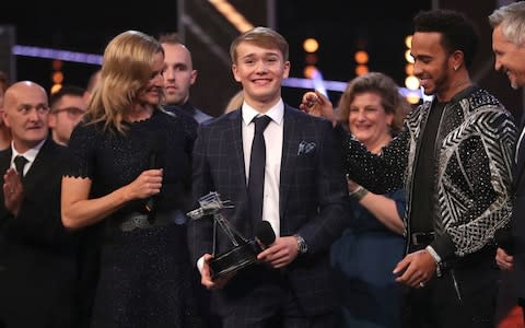 Billy Monger receives the Helen Rollason Award from Lewis Hamilton - Credit: PA Wire 