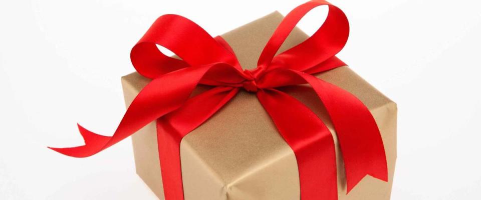 Golden gift box with red ribbon