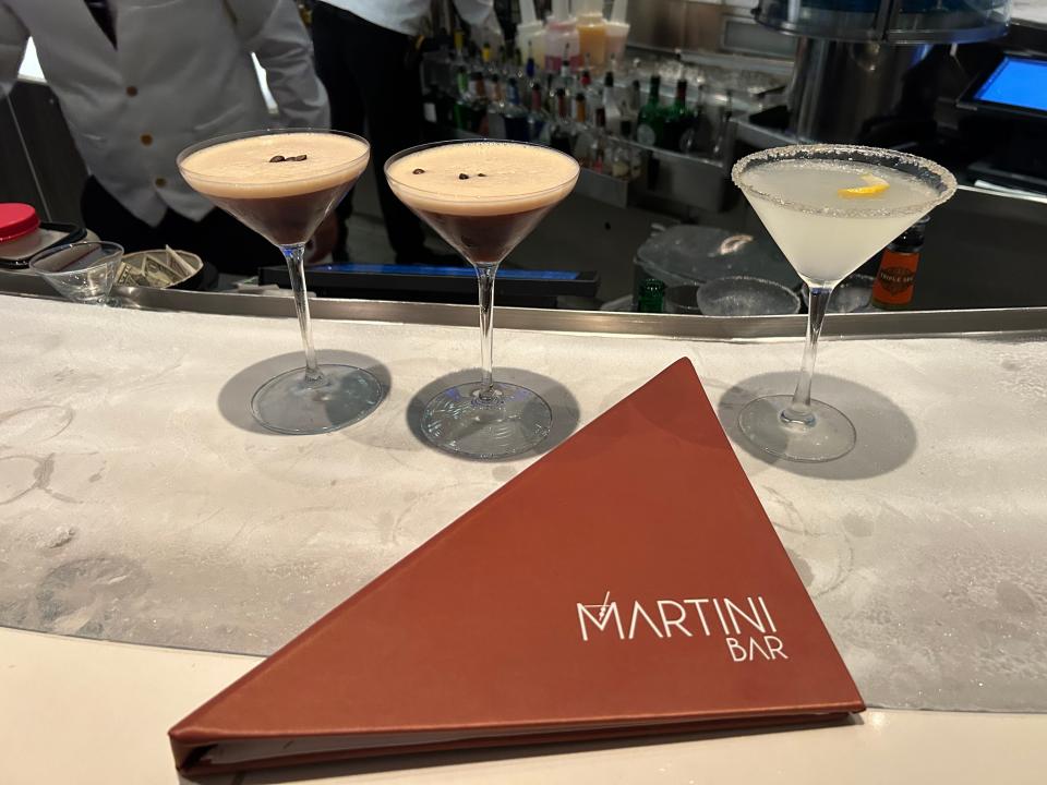 three martinis on a bar with a menu the reads martini bar in front of them