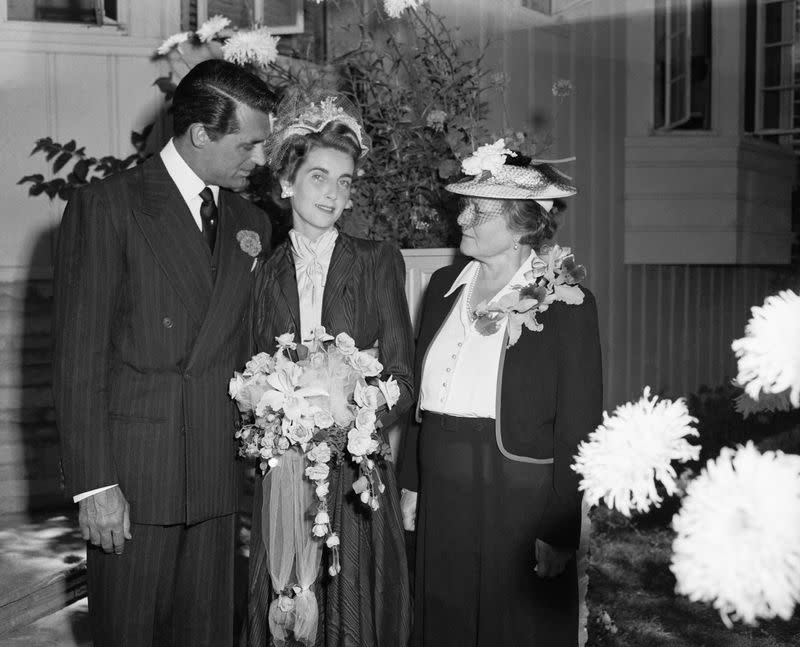 <p> For the heiress&apos;s third trip down the aisle in 1942, Barbara Hutton chose a more demure bridal look. She wed Hollywood leading man, Cary Grant, in a high-neck white ruffled dress and topped it off with a black coat dress and an intricate netted fascinator. </p>