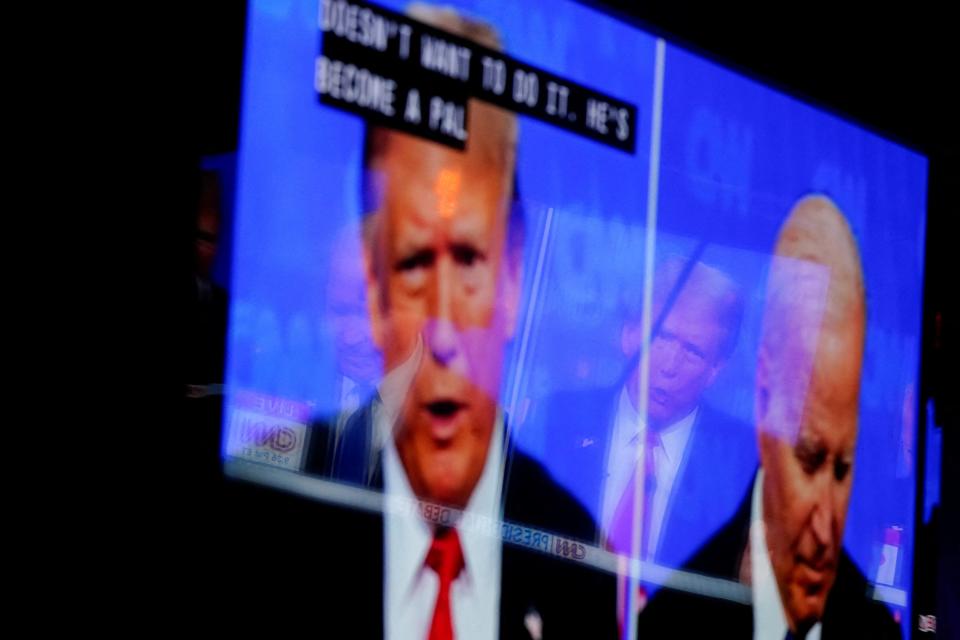 A TV screen shows U.S. President Joe Biden and Republican presidential candidate and former U.S. President Donald Trump, during a watch party for the first U.S. presidential debate hosted by CNN in Atlanta. June 27, 2024. REUTERS/Nathan Howard