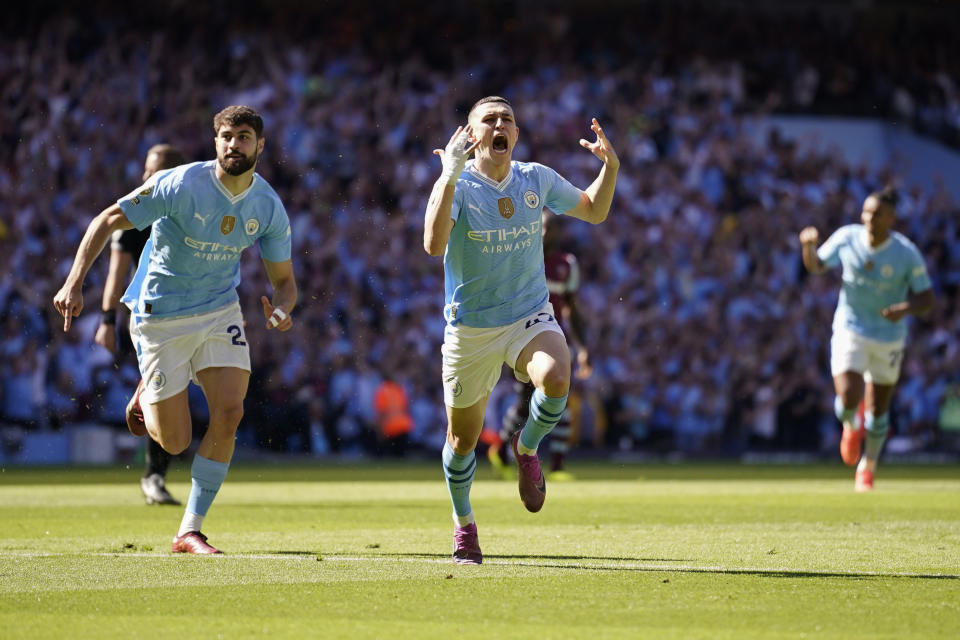 Manchester City's Phil Foden, center, celebrates after scoring his side's opening goal during the English Premier League soccer match between Manchester City and West Ham United at the Etihad Stadium in Manchester, England, Sunday, May 19, 2024. (AP Photo/Dave Thompson)