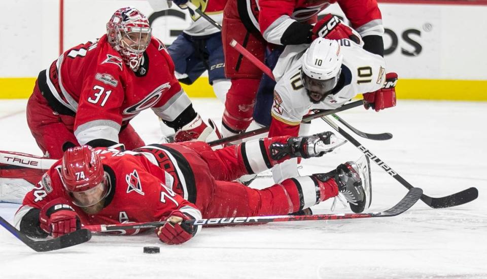 The Carolina Hurricanes Jaccob Slavin (74) dives after a loose puck in front of goalie Frederik Andersen (31) against the Florida Panthers in overtime during Game 1 of the Eastern Conference Finals on Thursday, May 18, 2023 at PNC Arena in Raleigh, N. C.