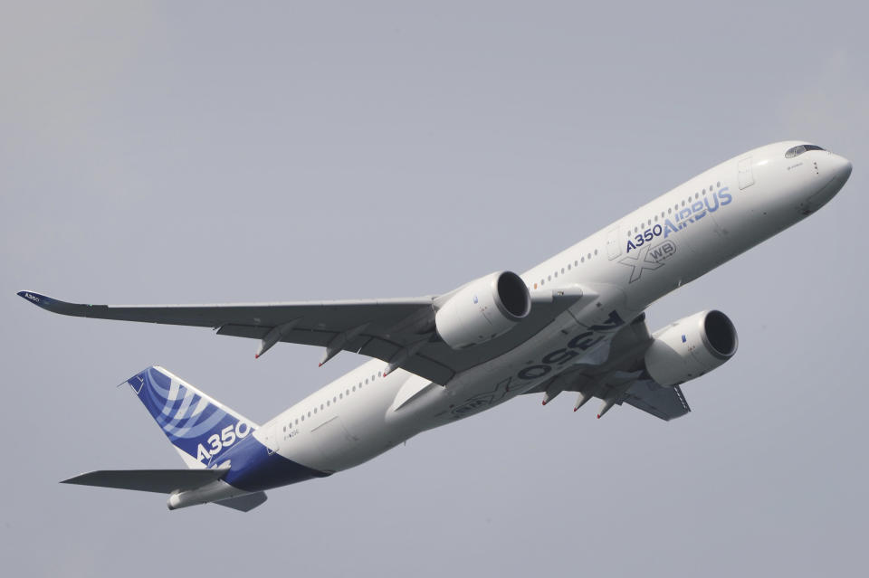 An Airbus A350-900 flies during an aerial display for a media preview ahead of the upcoming Singapore Air Show on Sunday, Feb. 9, 2014. (AP Photo/Joseph Nair)