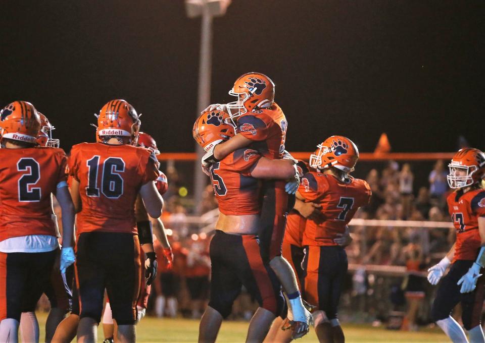 Isaiah Harbert (33) celebrates a touchdown with Brandon Lehman during Pana's 46-34 South Central Conference victory over Vandalia on Friday, August 25, 2023.