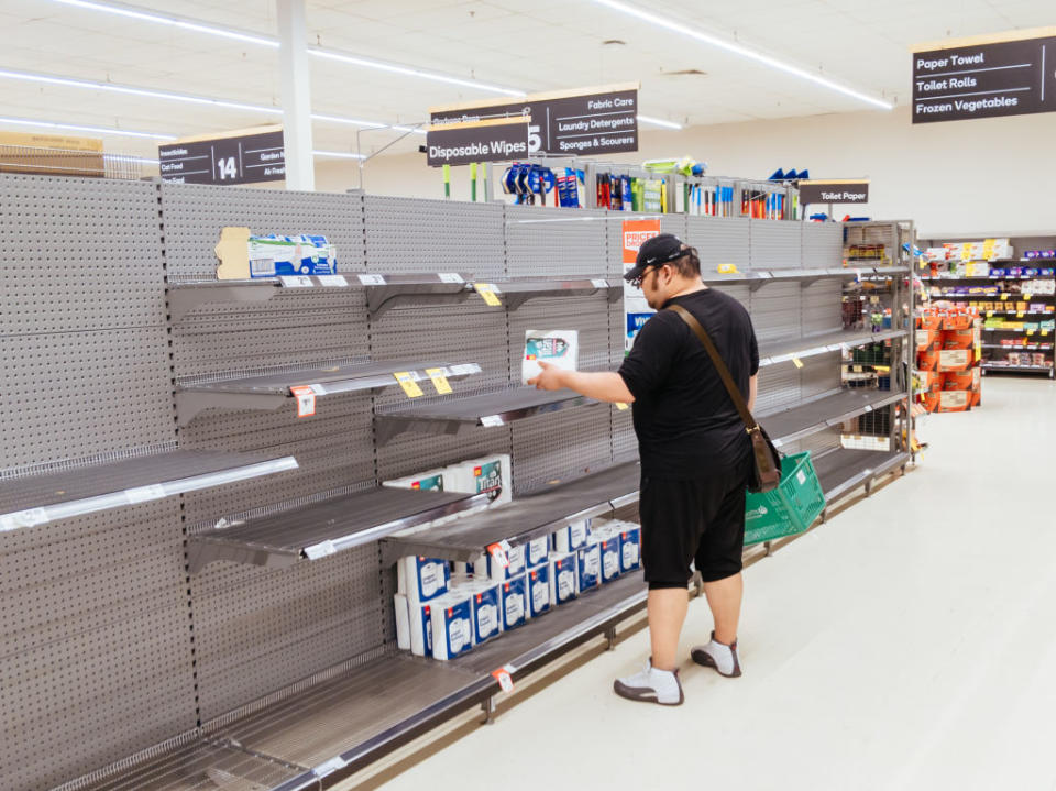  A man looks for toilet paper in a Melbourne Woolworths.