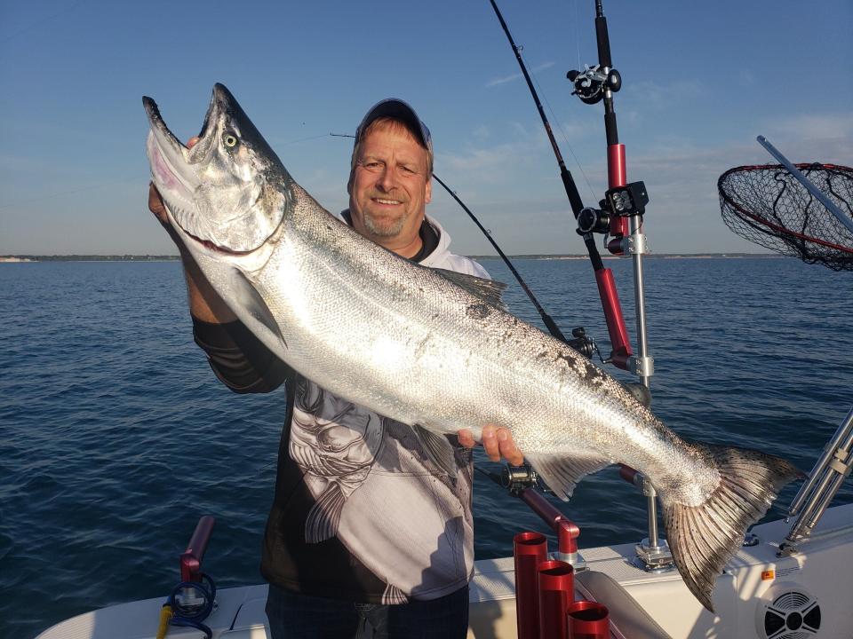 Capt. Dan Welsch of Sheboygan, owner of Dumper Dan's Sportfishing Charters, holds a chinook salmon he caught in June off Sheboygan.