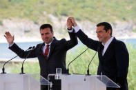 Greek Prime Minister Alexis Tsipras and Macedonian Prime Minister Zoran Zaev gesture before the signing of an accord to settle a long dispute over the former Yugoslav republic's name in the village of Psarades, in Prespes, Greece, June 17, 2018. REUTERS/Alkis Konstantinidis