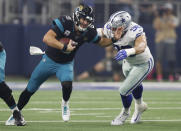 Jacksonville Jaguars quarterback Blake Bortles (5) is pressured by Dallas Cowboys defensive end Tyrone Crawford (98) in the first half of an NFL football game in Arlington, Texas, Sunday, Oct. 14, 2018. (AP Photo/Jim Cowsert)