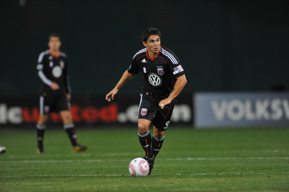 D.C. United star Jaime Moreno dribbles the ball on the field during a game.