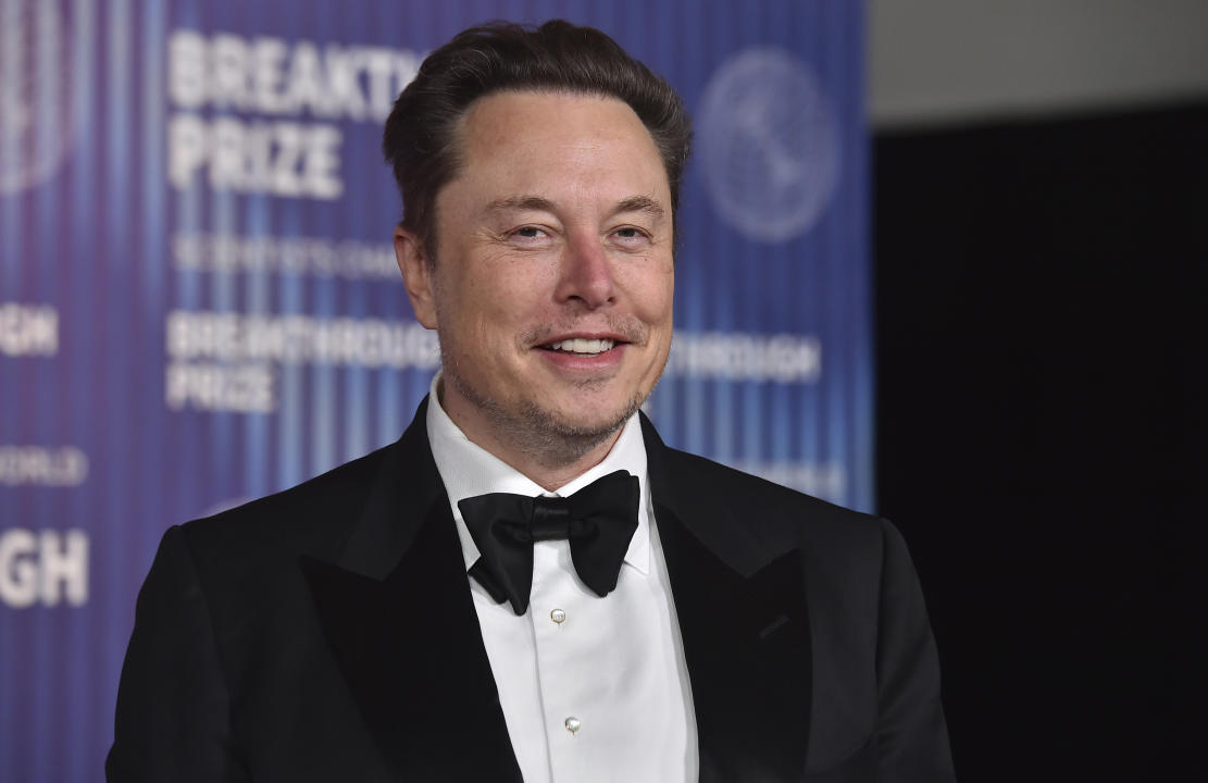 Elon Musk smiling in a tuxedo.