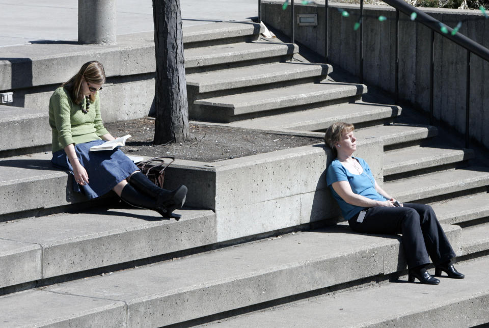 FILE - In this March 26, 2007, file photo, Toby Collodora, left, and Jen Oberg, right enjoy their lunch hour on Peavey Plaza in Minneapolis. Peavey Plaza, Chicago’s Wrigley Field, New Orleans’ Saenger Theatre and a historic Los Angeles’ shipbuilding center have joined a list of sites being saved thanks to the efforts of historic preservationists in 2013. The National Trust for Historic Preservation compiled a list of 10 sites saved and 10 sites lost in 2013. (AP Photo/Jim Mone, File)