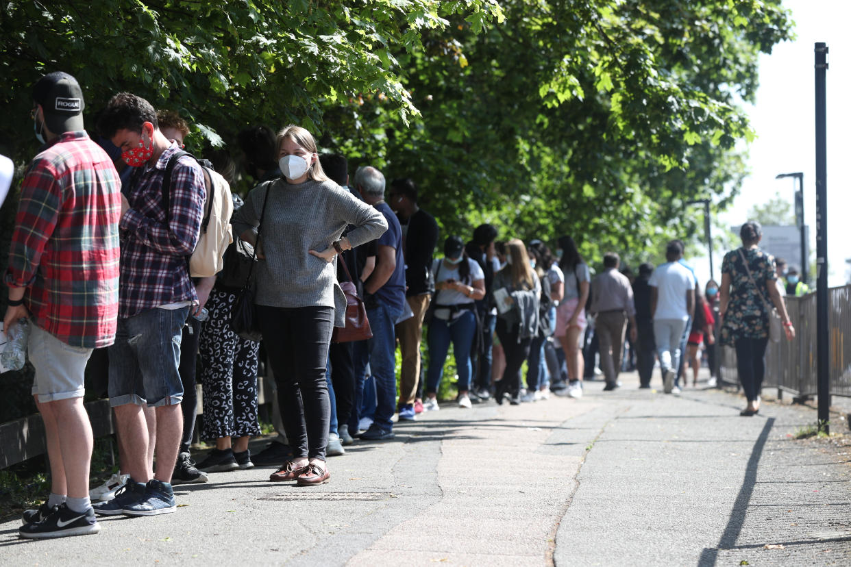 People queuing to go into Belmont Health Centre in Harrow. (PA)