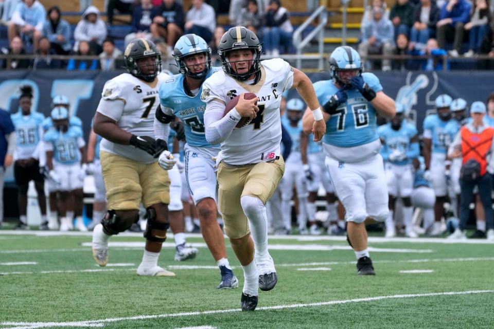 Bryant quarterback Zevi Eckhaus gains some yardage on a broken play that later set up a first-half touchdown for the Bulldogs at URI on Saturday.