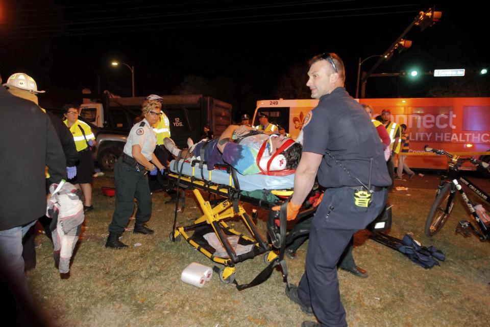 Crash: New Orleans emergency personnel attend to an injured parade watcher (AP)