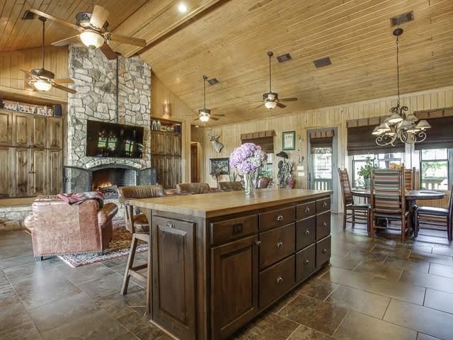 Massive fireplaces and wood-beamed ceilings give the ranch its rustic charm.