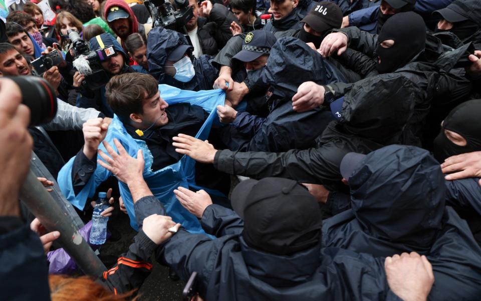 Riot police grabbed several protesters and hauled them aggressively away as they moved in to clear the demonstrations