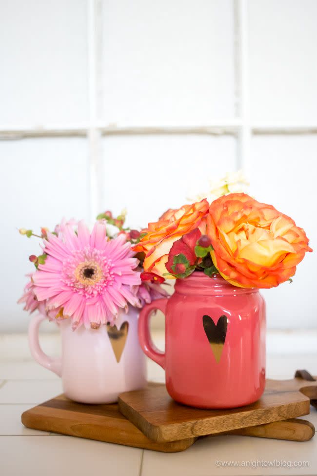 pink and orange flowers in mugs