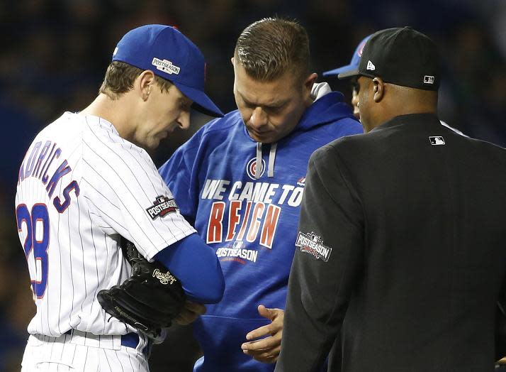 Cubs starting pitcher Kyle Hendricks checks on his arm after getting hit by a ball in the fourth inning of NLDS Game 2. (AP)