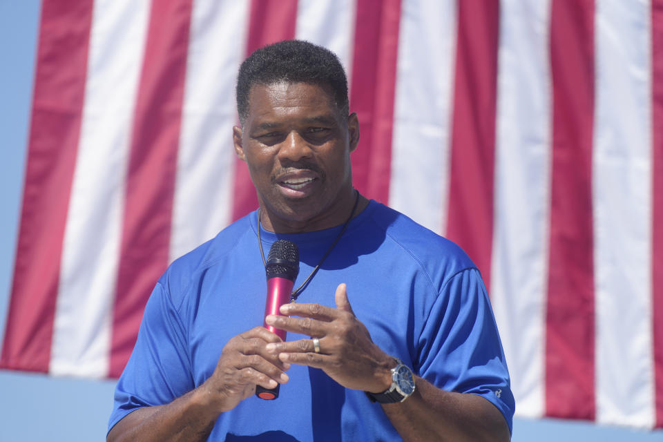 Georgia GOP Senate nominee Herschel Walker smiles during remarks during a campaign stop at Battle Lumber Co. on Thursday, Oct. 6, 2022, in Wadley, Ga. Walker's appearance was his first following reports that a woman who said Walker paid for her 2009 abortion is actually mother of one of his children - undercutting Walker's claims he didn't know who she was .(AP Photo/Meg Kinnard)