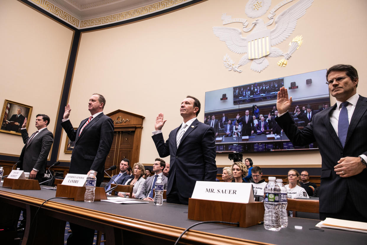 Witnesses are sworn in at a hearing on the 