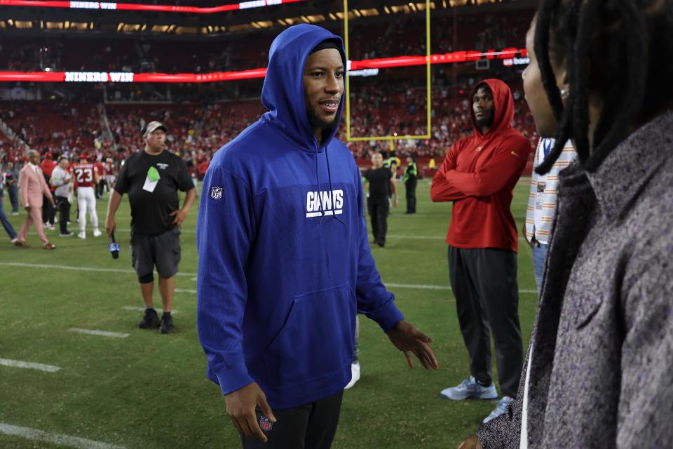 Injured New York Giants running back Saquon Barkley stands on the field after an NFL football game against the San Francisco 49ers in Santa Clara, Calif., Thursday, Sept. 21, 2023. (AP Photo/Jed Jacobsohn)