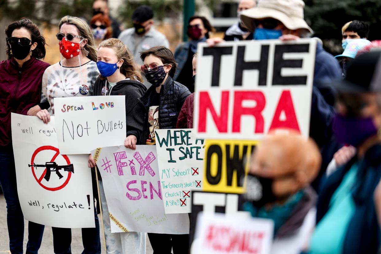 <p>File image: People link arms at a gun reform rally at the Colorado State Capitol on 28 March, 2021 in Denver, Colorado </p> (Getty Images)