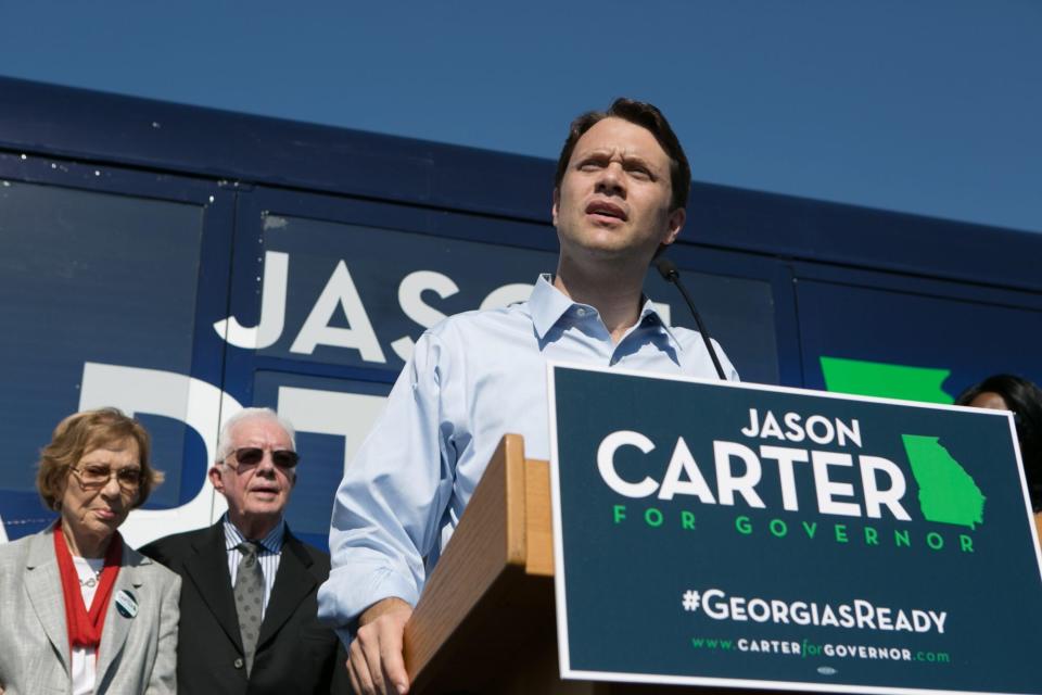 COLUMBUS, GA - OCTOBER 27: Georgia Democratic gubernatorial candidate and State Sen. Jason Carter (R) speaks during a campaign event with his grandparents, former U.S. President Jimmy Carter (C) and former first lady Rosalynn Carter, at Emmanuel Christian Community Church on October 27, 2014 in Columbus, Georgia. Jason Carter is running against the Republican incumbent Georgia Republican Gov. Nathan Deal. (Photo by Jessica McGowan/Getty Images)