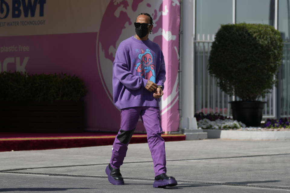 Mercedes driver Lewis Hamilton of Britain arrives at the Yas Marina racetrack in Abu Dhabi, United Arab Emirates, Thursday, Dec. 9, 2021. (AP Photo/Hassan Ammar)