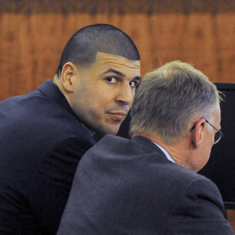 Former tight end for the New England Patriots Aaron Hernandez (L) sits with his attorney Charles Rankin during his trial at the Bristol County Superior Court in Fall River, Massachusetts April 13, 2015. The jury in the murder trial of former National Football League player Aaron Hernandez began its fifth day of deliberations on Monday over whether he is guilty of killing an acquaintance in 2013, in the first of two murder trials he will face this year. REUTERS/Ted Fitzgerald/Pool