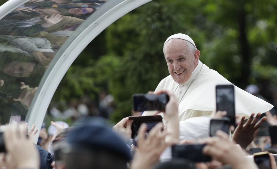 Pope Francis is driven through the crowd as he arrives for a meeting with young people and families, in Iasi, Romania, Saturday, June 1, 2019. Francis began a three-day pilgrimage to Romania on Friday that in many ways is completing the 1999 trip by St. John Paul II that marked the first-ever papal visit to a majority Orthodox country. (AP Photo/Andrew Medichini)