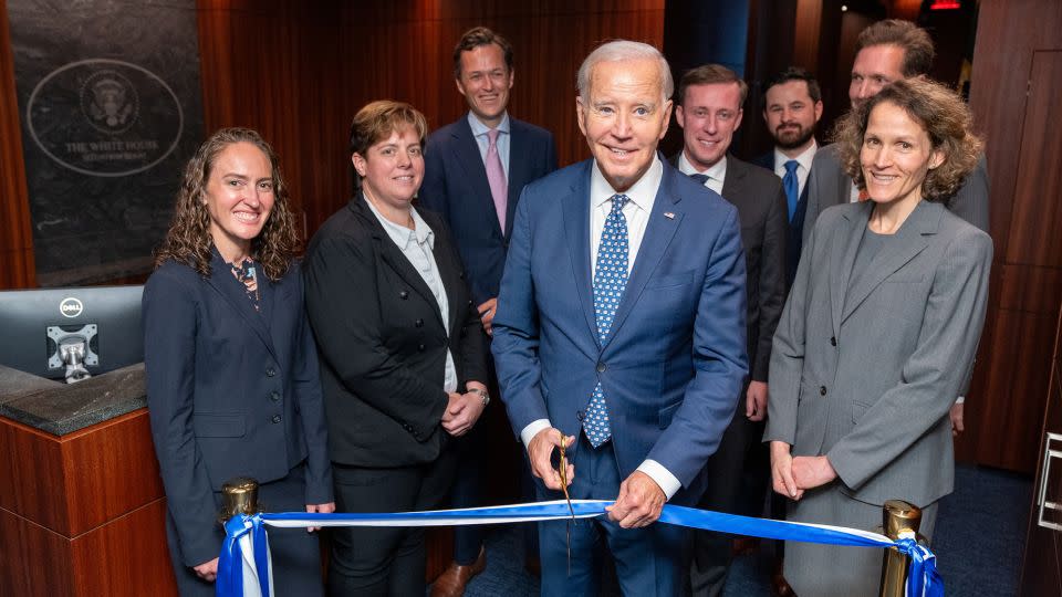 U.S. President Joe Biden is seen cutting the ribbon to open the newly renovated White House Situation Room in a White House handout photo, as he stands with White House and National Security Council staff including National Security Advisor Jake Sullivan in the West Wing of the White House in Washington, DC. Source: The White House - Adam Schultz/The White House/Reuters