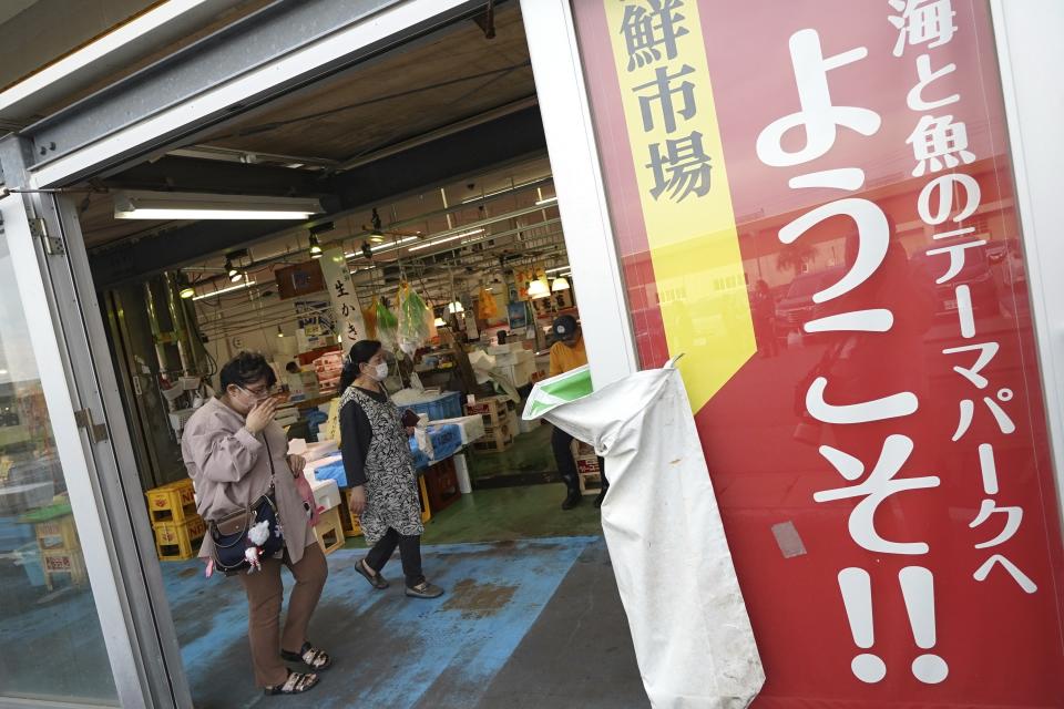 Visitors walk at the seafood market "Lalamew" near the Onahama fish port in Iwaki City, Fukushima Prefecture, on Oct. 19, 2023 in Iwaki, northeastern Japan. Fishing communities in Fukushima feared devastating damage to their businesses from the tsunami-wrecked nuclear power plant’s ongoing discharge of treated radioactive wastewater into the sea. Instead, they're seeing increased consumer support as people eat more fish, a movement in part helped by China’s ban on Japanese seafood. (AP Photo/Eugene Hoshiko)