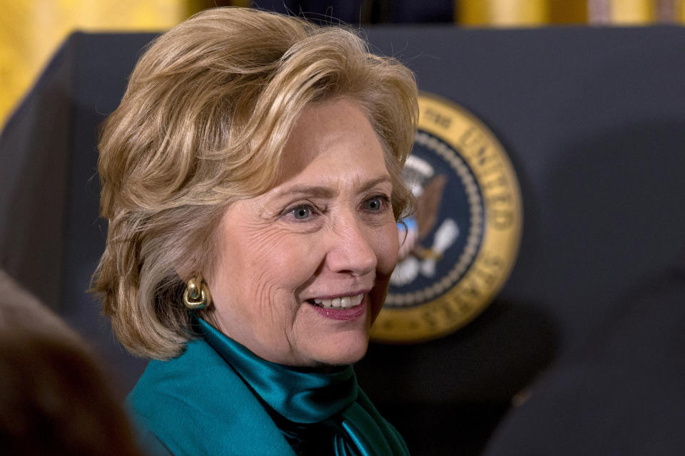 Former Secretary of State Hillary Rodham Clinton walks past the Presidential seal in the East Room of the White House in Washington, Wednesday, Nov. 20, 2013, after a ceremony where President Barack Obama awarded the Presidential Medal of Freedom to former President Bill Clinton and others. 