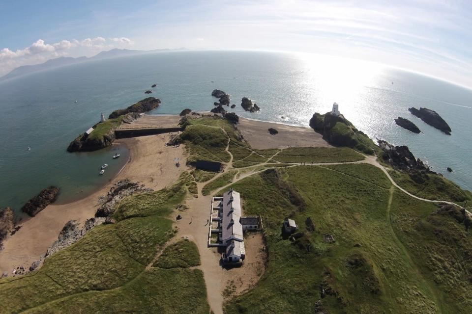 <p>The jagged coastline of Anglesey Island is captured from a drone’s eye view.</p><p><br></p>