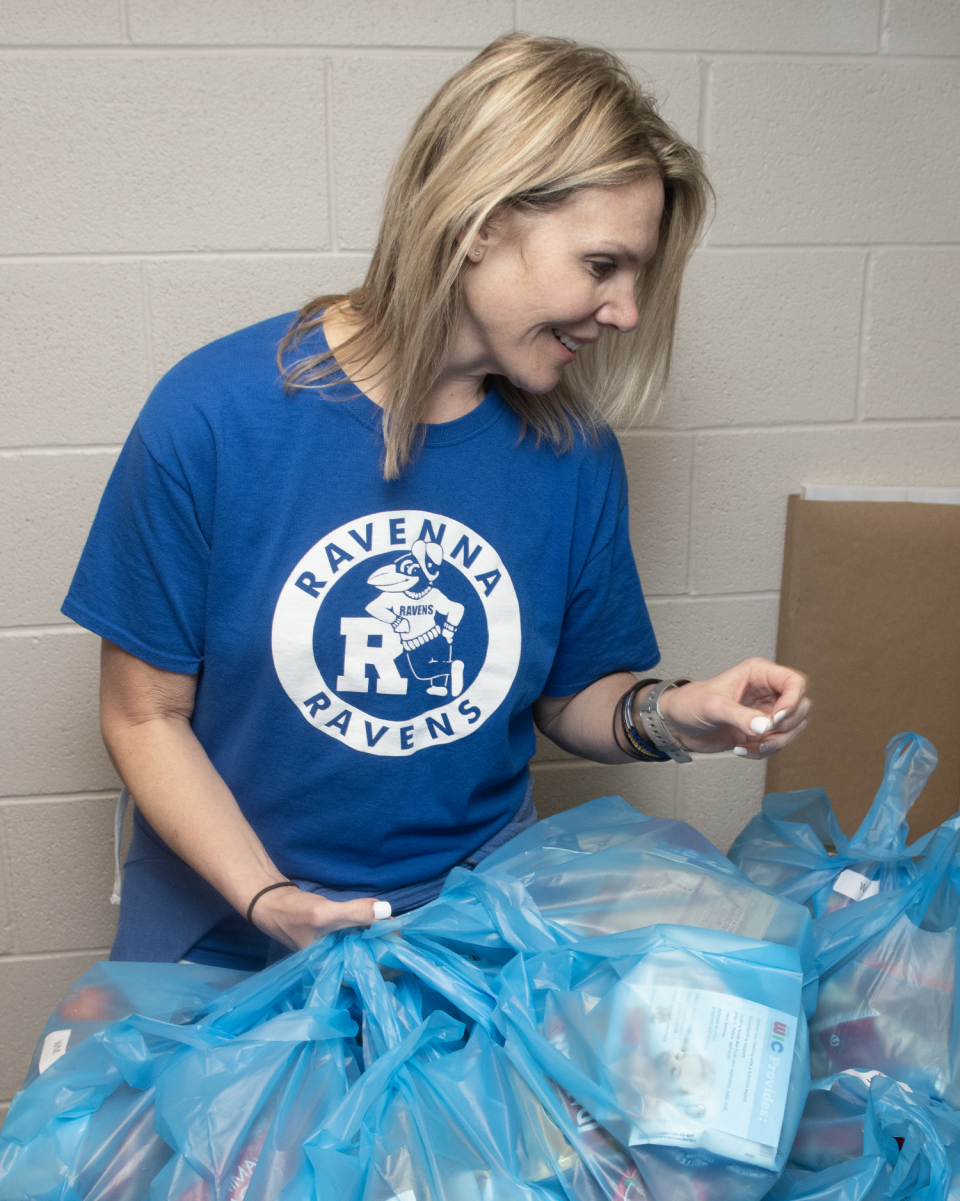 Raven Packs Vice President Rebecca Schneider collects filled packs for distribution during a volunteer event April 27 at Portage Community Chapel in Ravenna.