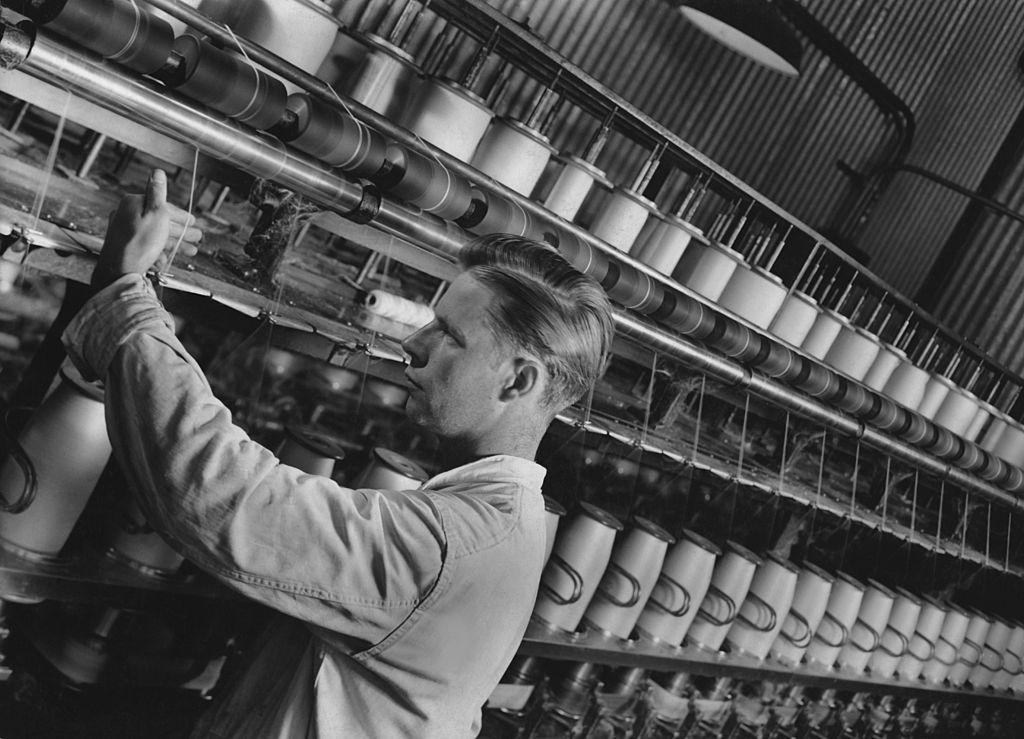 A man working on a glass yarn production line circa 1960.