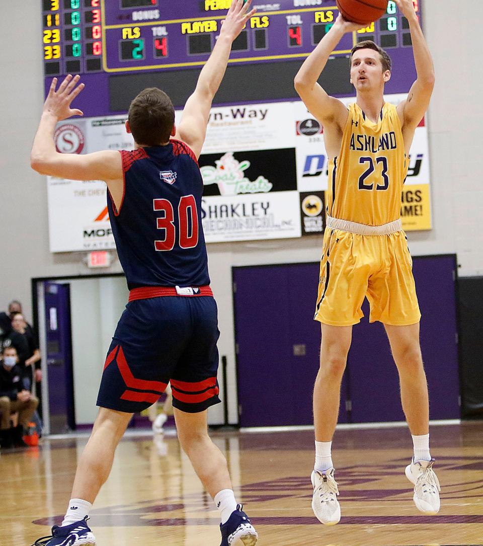 Ashland University's Evan Bainbridge (23) puts up a shot against Malone University's Levi Seiler (30) during college men's basketball action Wednesday, Dec. 29, 2021 at Kates Gymnasium. TOM E. PUSKAR/TIMES-GAZETTE.COM