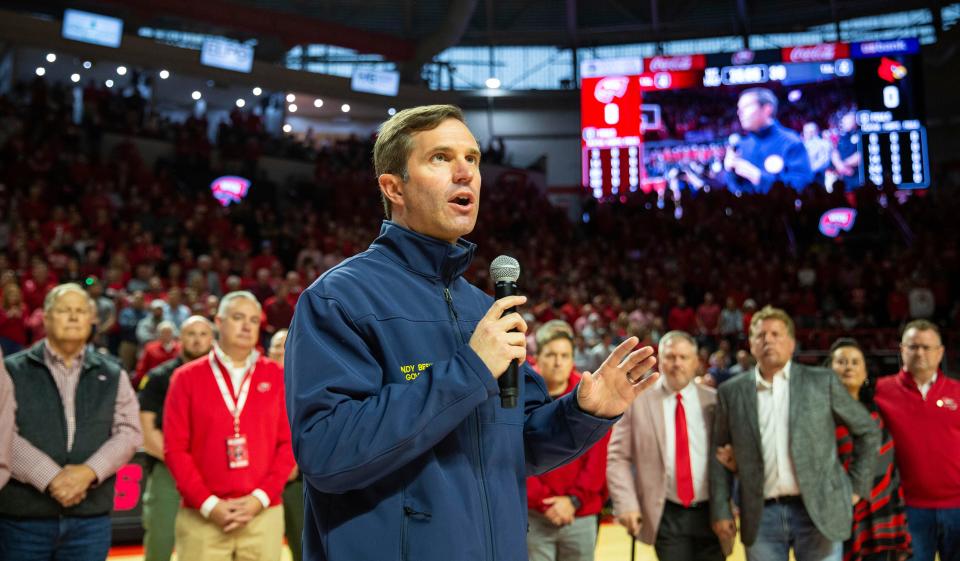 Gov. Andy Beshear addresses audience members with a message of hope for the state's tornado victims before the start of the Western Kentucky University men's basketball game against the University of Louisville at E.A. Diddle Arena in Bowling Green, Ky., Saturday, Dec. 18, 2021. (Grace Ramey/Daily News via AP)