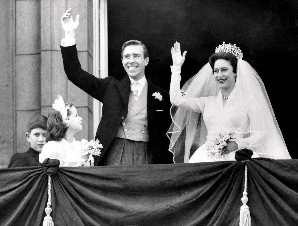 The newly-wed Princess Margaret and her husband, Antony Armstrong-Jones wave from Buckingham Palace on their wedding day in 1960 (Getty)