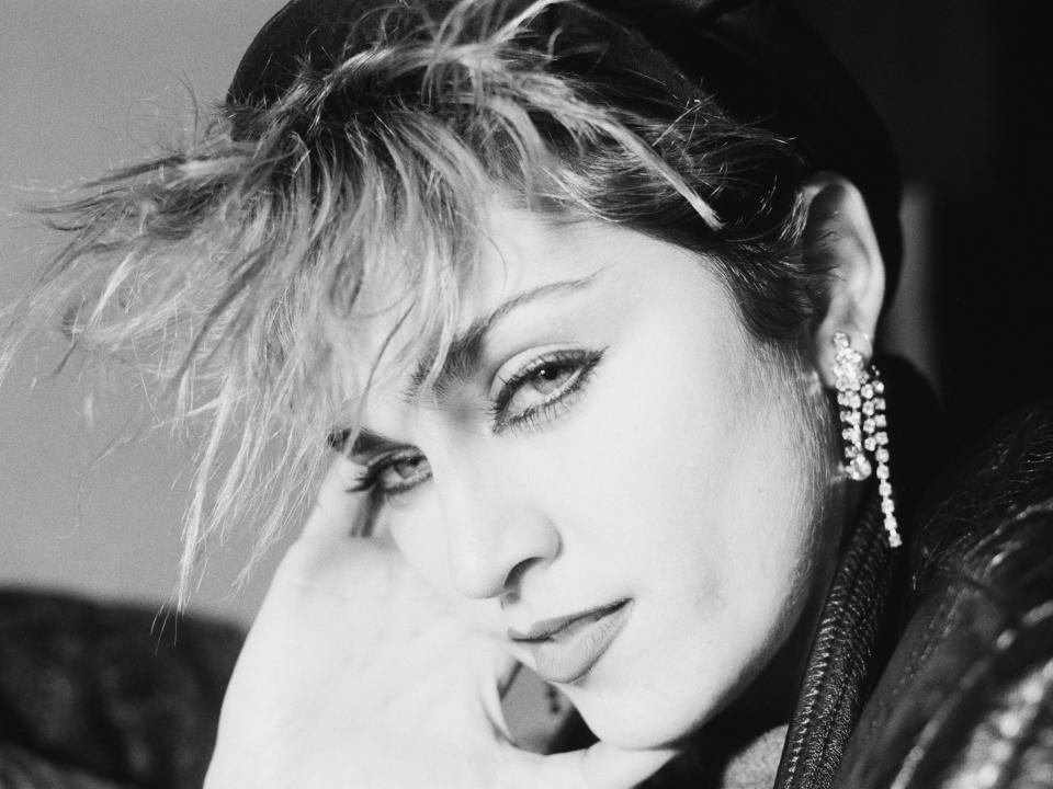 Black and white close up of Madonna with spiky bangs.