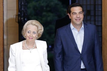 Outgoing Greek Prime Minister Alexis Tsipras (R) greets Greece's Supreme top Court judge Vassiliki Thanou (L) after her swearing in ceremony as the country's caretaker Prime Minister, at the handover ceremony at the prime minister's office at Maximos Mansion in Athens, Greece August 27, 2015. REUTERS/Stoyan Nenov