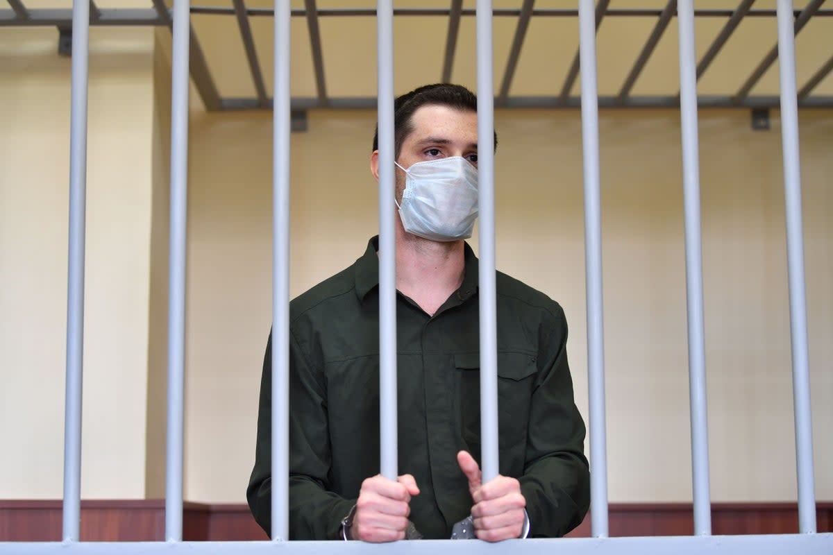 Mr Reed was charged with attacking police and is pictured standing inside a defendants’ cage during his verdict hearing at Moscow’s Golovinsky district court on 30 July 30 (AFP via Getty Images)