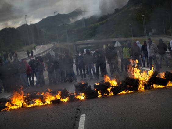 Demonstrators block a motorway in protest of government plans to scale back mining in 2012 (AP)